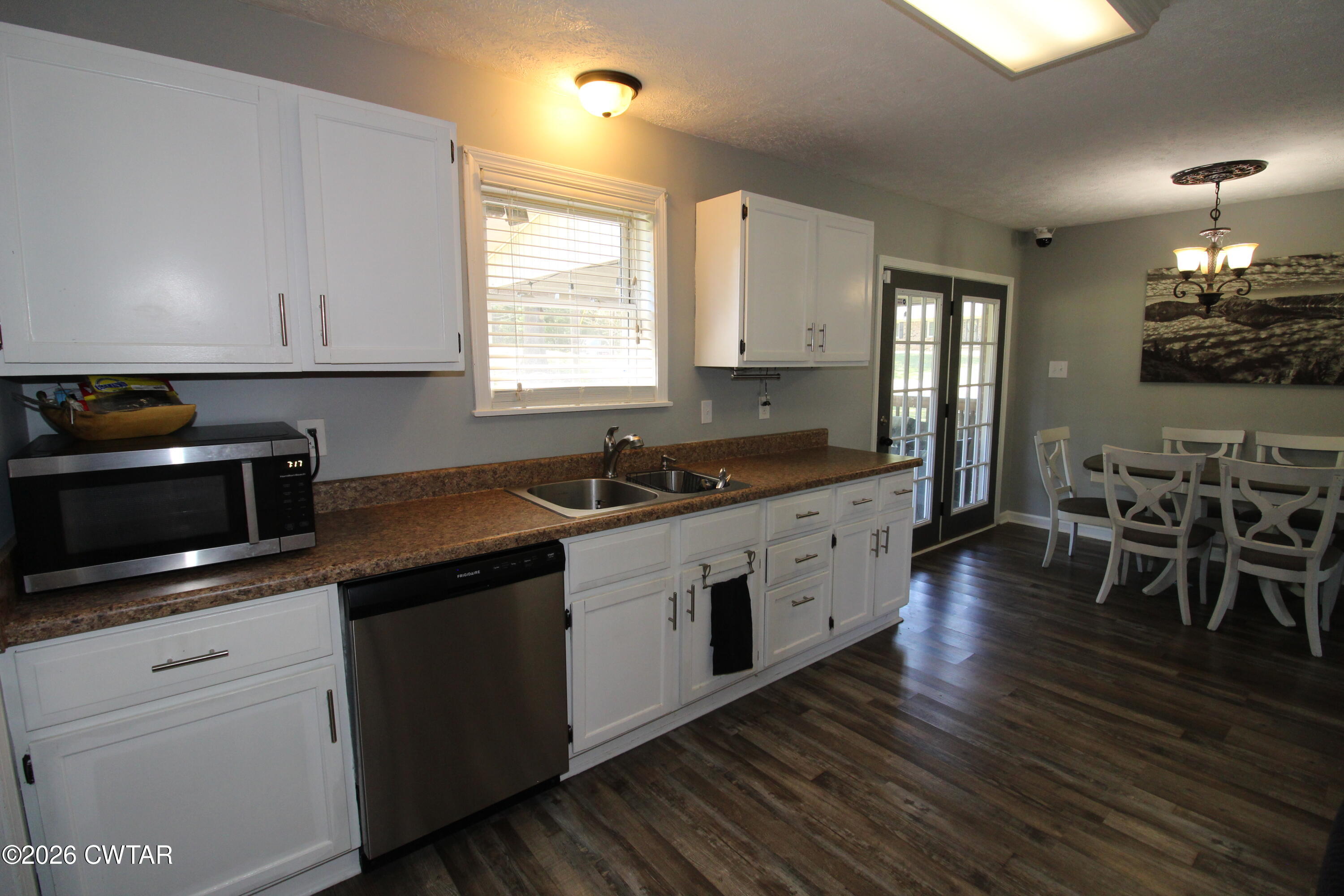 33 Kipling Drive Jackson, TN 38305 - Photo 6 of 20 a kitchen with stainless steel appliances kitchen island granite countertop a stove a sink and a microwave