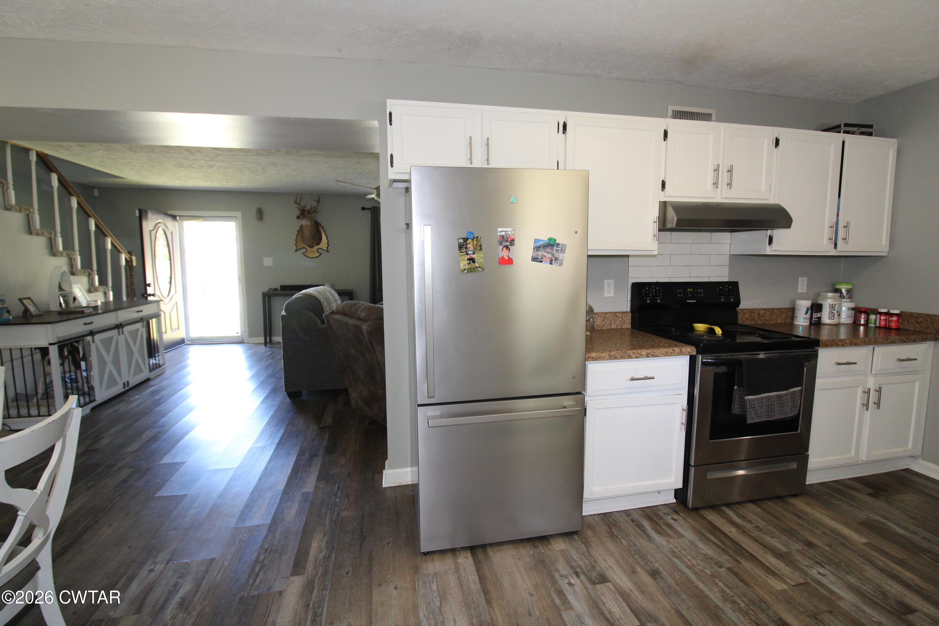 33 Kipling Drive Jackson, TN 38305 - Photo 10 of 20 a kitchen with granite countertop a refrigerator stove top oven and cabinets with wooden floor