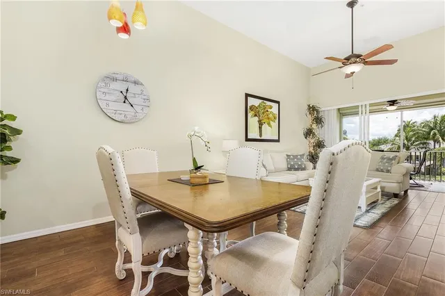 a view of a dining room with furniture and a chandelier