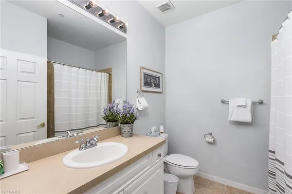 a bathroom with a sink toilet and a mirror