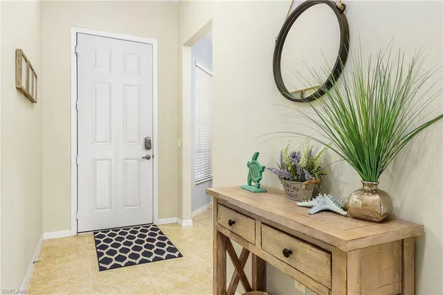 a bathroom with a sink a mirror and a potted plant