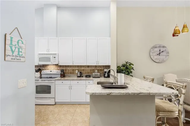 a kitchen with a stove a sink and cabinets
