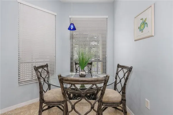a view of a dining room with furniture and window