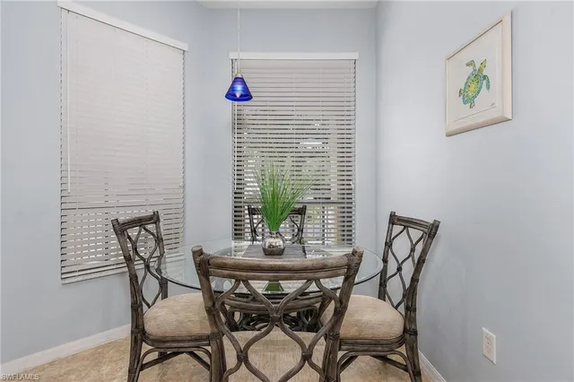 a view of a dining room with furniture and window