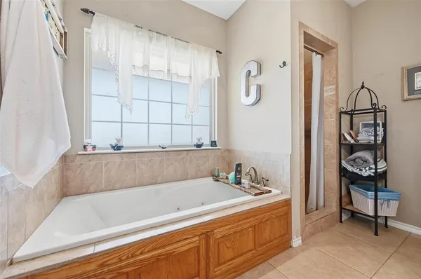 a living room with furniture a flat screen tv and a window