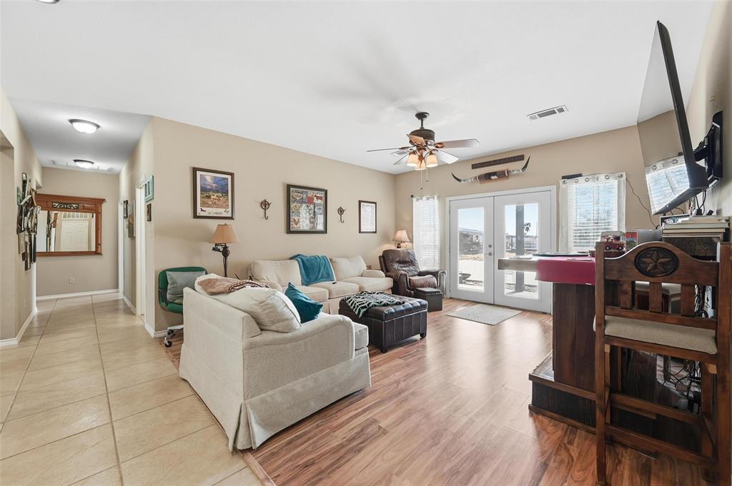 346 Forreston Road Waxahachie, TX 75165 - Photo 14 of 36 a living room with furniture a flat screen tv and kitchen view