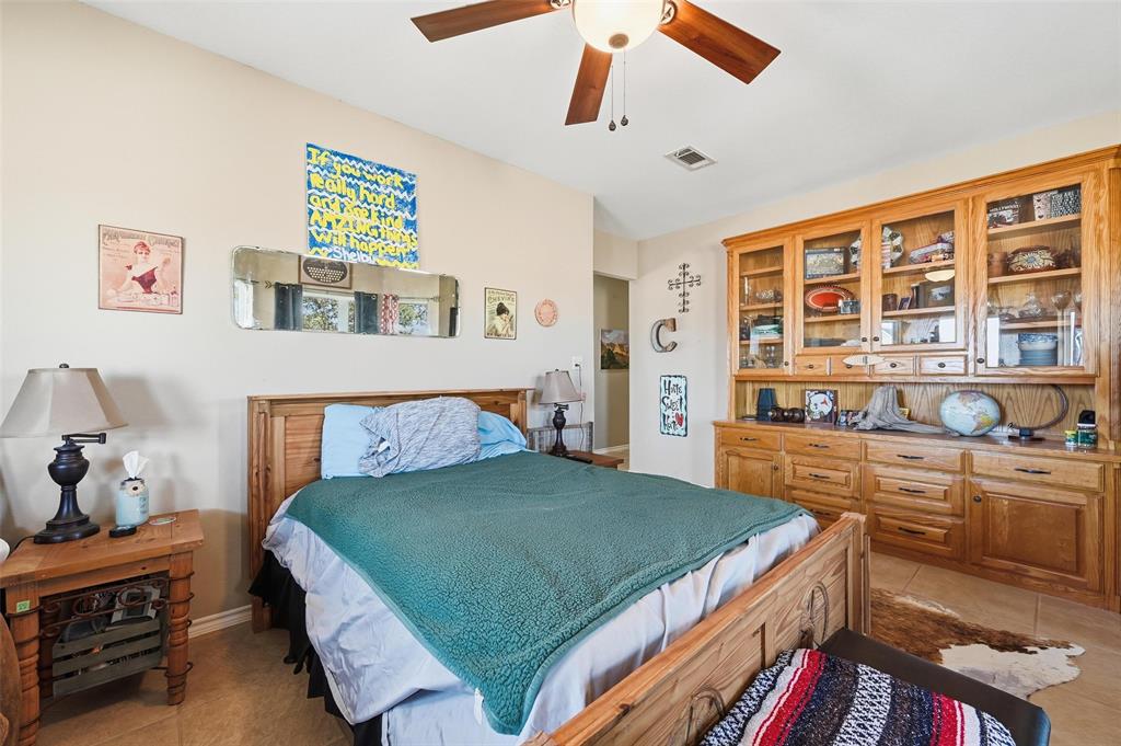 346 Forreston Road Waxahachie, TX 75165 - Photo 15 of 36 a bed room with a bed and a book shelf