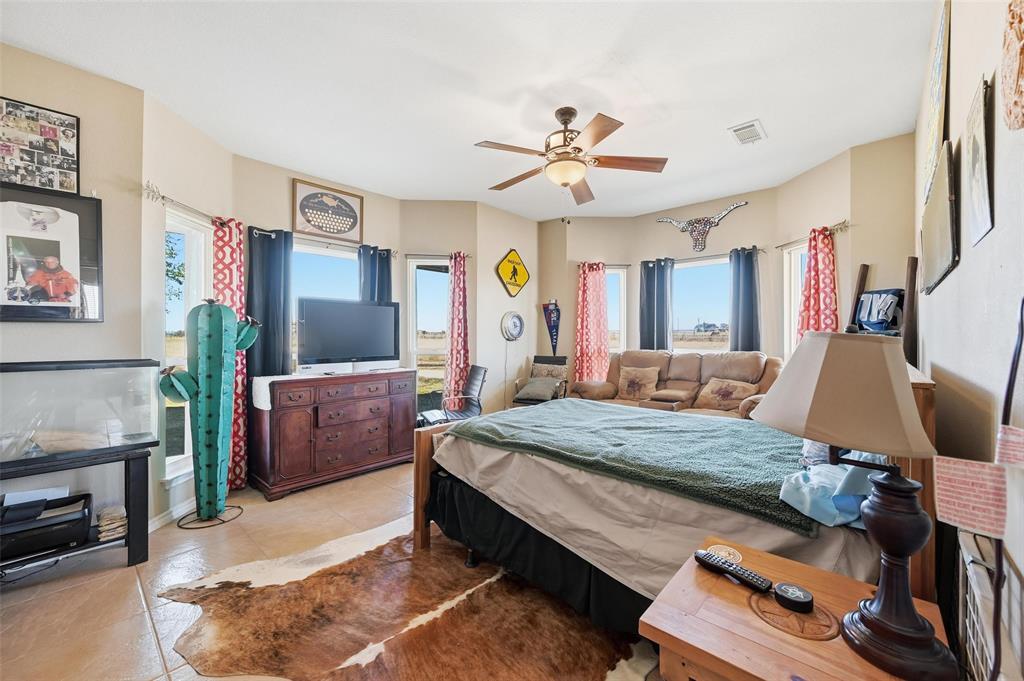 346 Forreston Road Waxahachie, TX 75165 - Photo 16 of 36 a bedroom with a bed a dresser and potted plants on the dresser