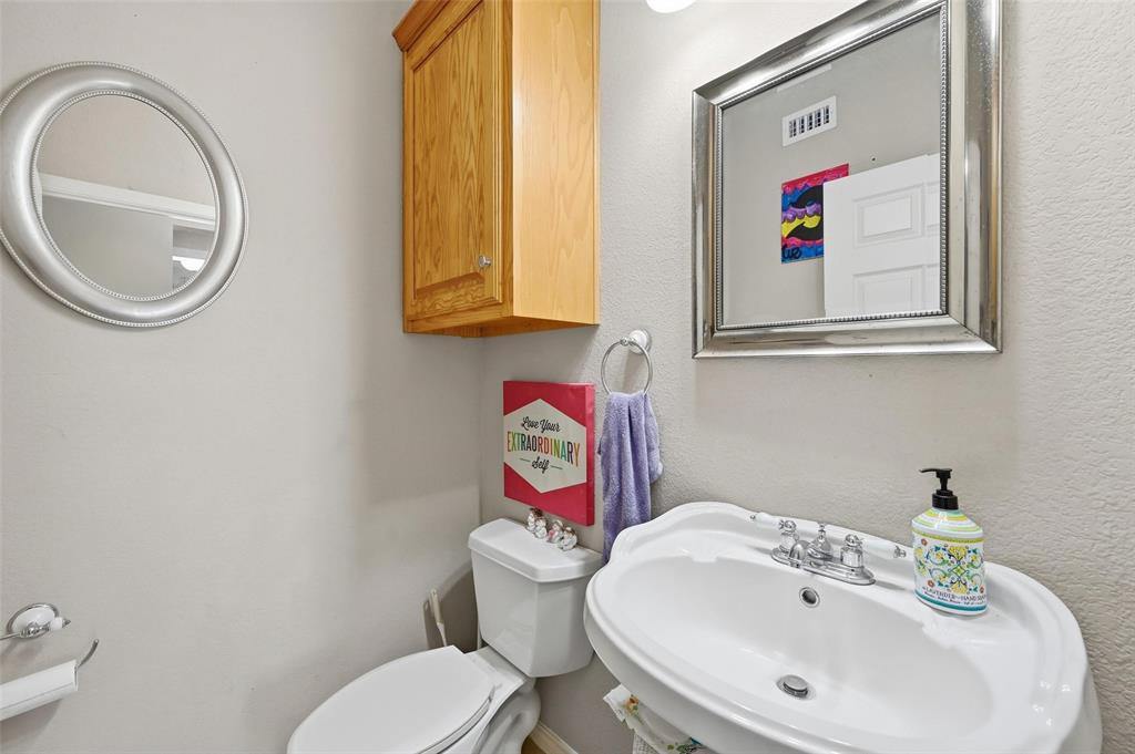 346 Forreston Road Waxahachie, TX 75165 - Photo 17 of 36 a bathroom with a toilet sink and mirror