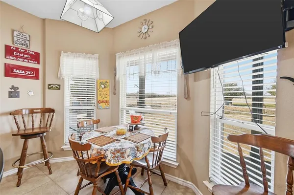 a view of a dining room with furniture and chandelier