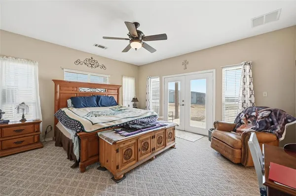 a bathroom with a granite countertop tub sink and mirror