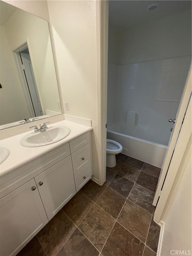 30433 Village Knoll Drive Menifee, CA 92584 - Photo 12 of 12 a bathroom with a sink a toilet and a mirror