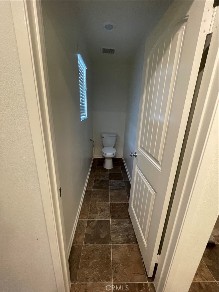 30433 Village Knoll Drive Menifee, CA 92584 - Photo 8 of 12 a view of a hallway with wooden floor and staircase