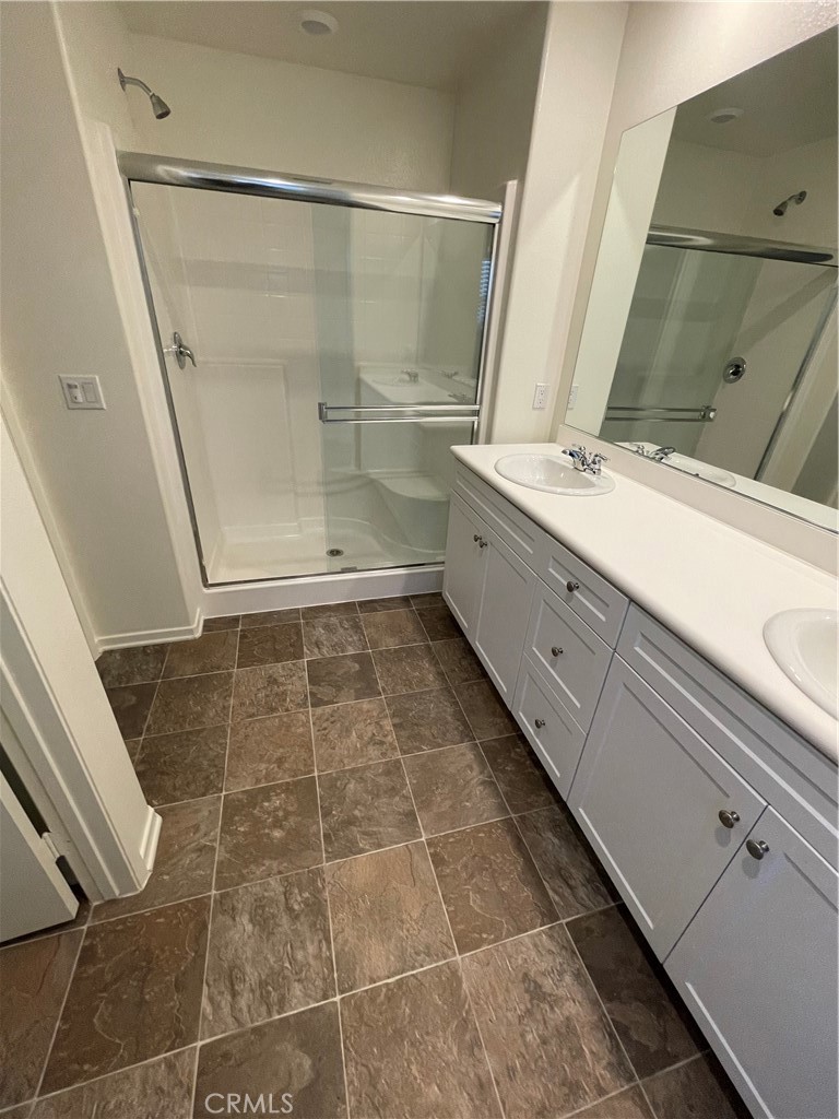 30433 Village Knoll Drive Menifee, CA 92584 - Photo 9 of 12 a bathroom with a granite countertop sink toilet and shower