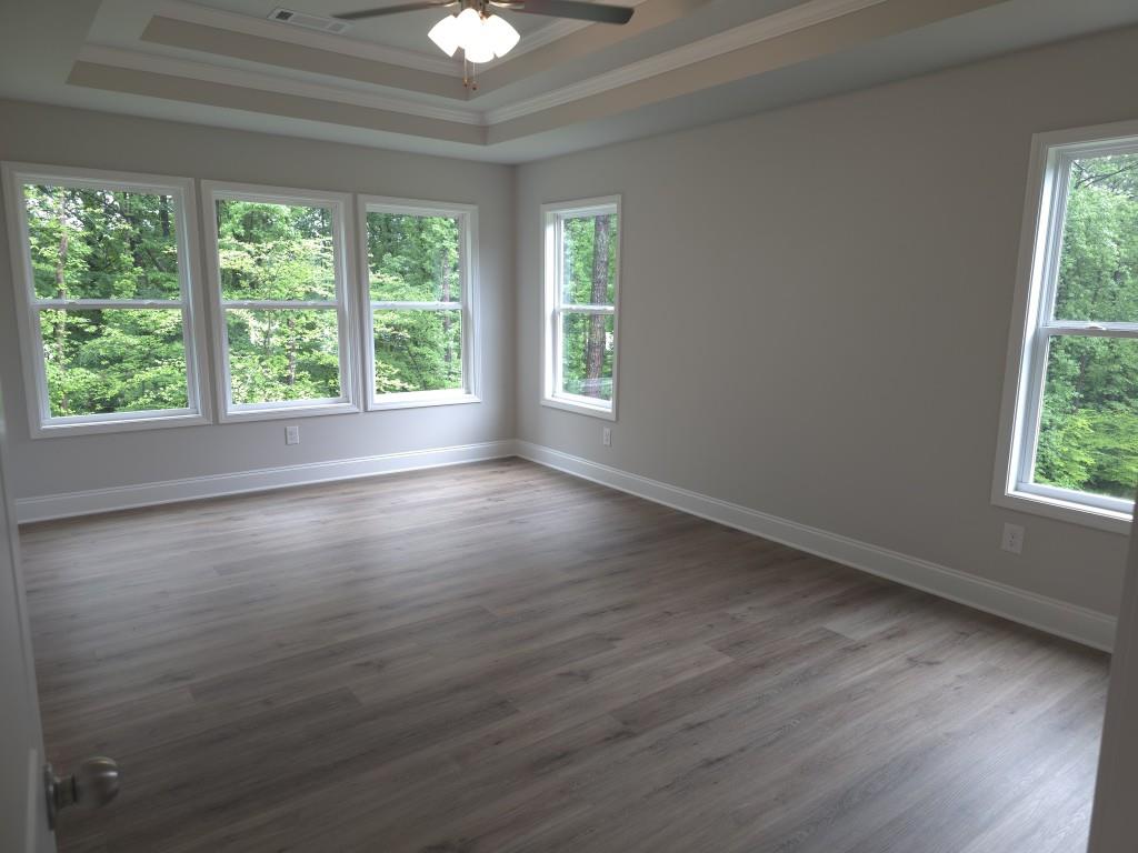 4240 Cavalier Way Duluth, GA 30097 - Photo 27 of 46 a view of empty room with wooden floor and fan