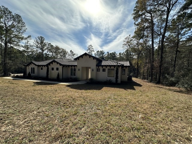 875 Lonestar Road Huntsville, TX 77340 - Photo 2 of 24 a house with trees in front of it