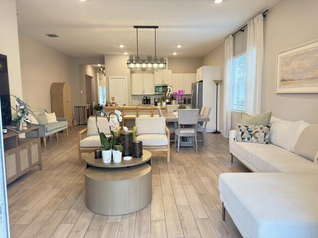 19696 Weathervane Way Loxahatchee, FL 33470 - Photo 7 of 39 a living room with furniture and a chandelier