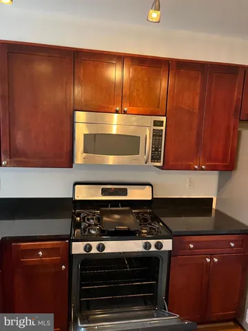 a stove top oven sitting inside of a kitchen
