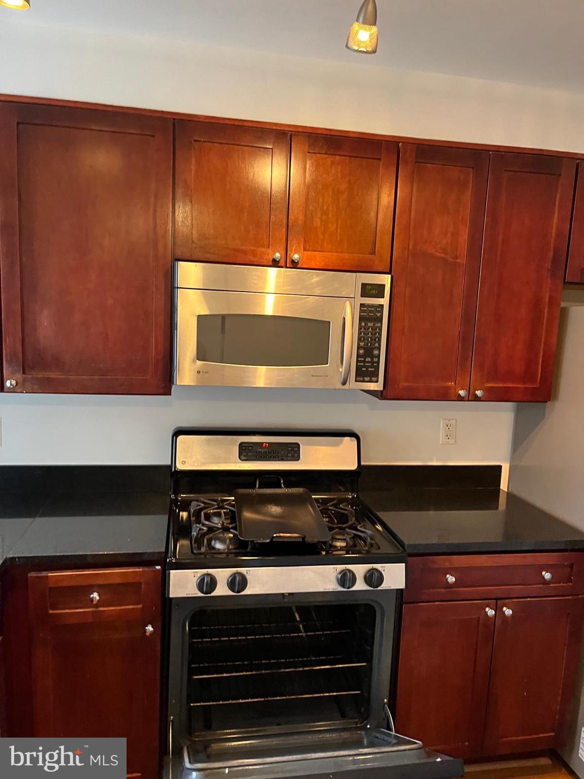 1417 Newton Street Northwest, Unit 204 Washington, DC 20010 - Photo 4 of 11 a stove top oven sitting inside of a kitchen