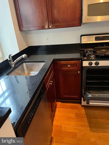 a kitchen with sink and cabinets