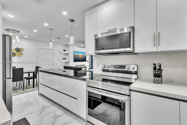 a kitchen with a sink stainless steel appliances and cabinets
