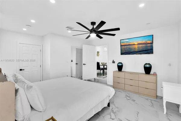 a bedroom with a bed and a flat screen tv