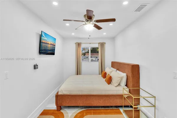 a bedroom with a bed and a flat screen tv