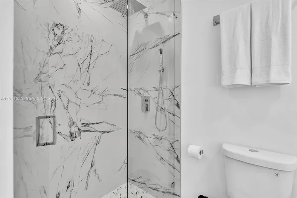 a bathroom with a shower and toilet