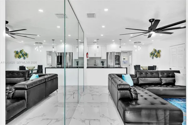 a living room with furniture and a ceiling fan