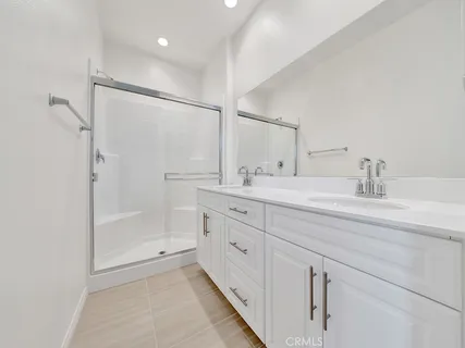 a bathroom with a shower sink and mirror