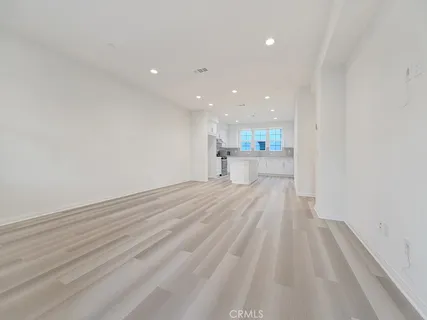 a view of a kitchen with a sink and wooden floor