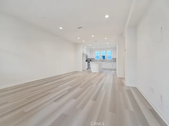 a view of a kitchen with a sink and wooden floor
