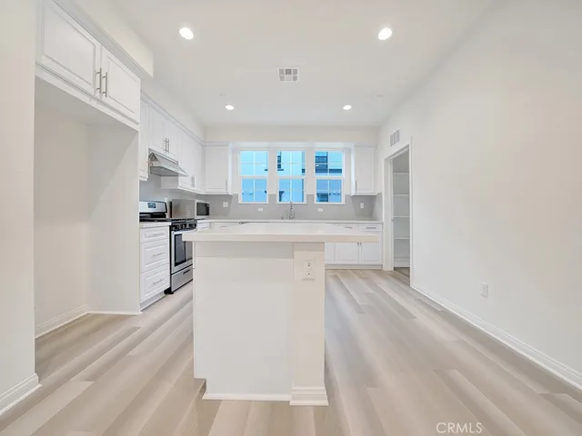 a kitchen with refrigerator and cabinets