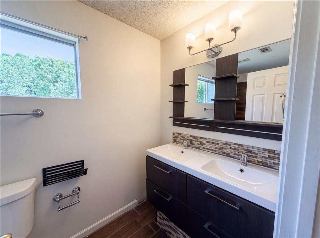 3753 Soapstone Road Decatur, GA 30034 - Photo 14 of 26 a bathroom with a sink vanity mirror and toilet