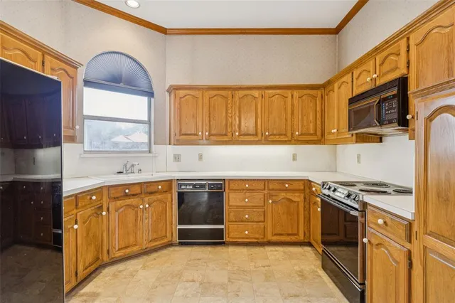 a kitchen with stainless steel appliances granite countertop a stove sink and cabinets