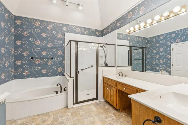 a spacious bathroom with a tub sink shower and mirror