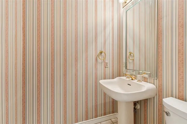 a bathroom with a sink a mirror and a shower curtain