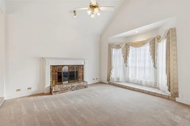 a view of an empty room with a fireplace