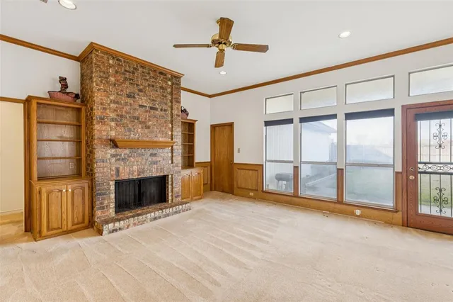 a view of an empty room with exposed radiator and fireplace