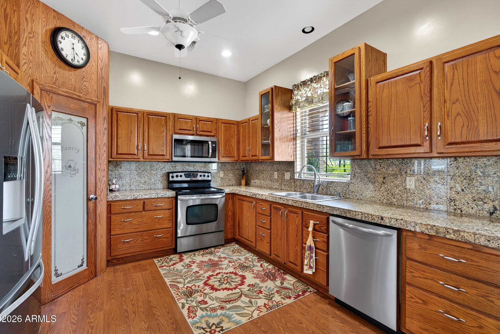 2929 West New River Road New River, AZ 85087 - Photo 11 of 53 a kitchen with stainless steel appliances granite countertop a stove top oven a sink and a refrigerator