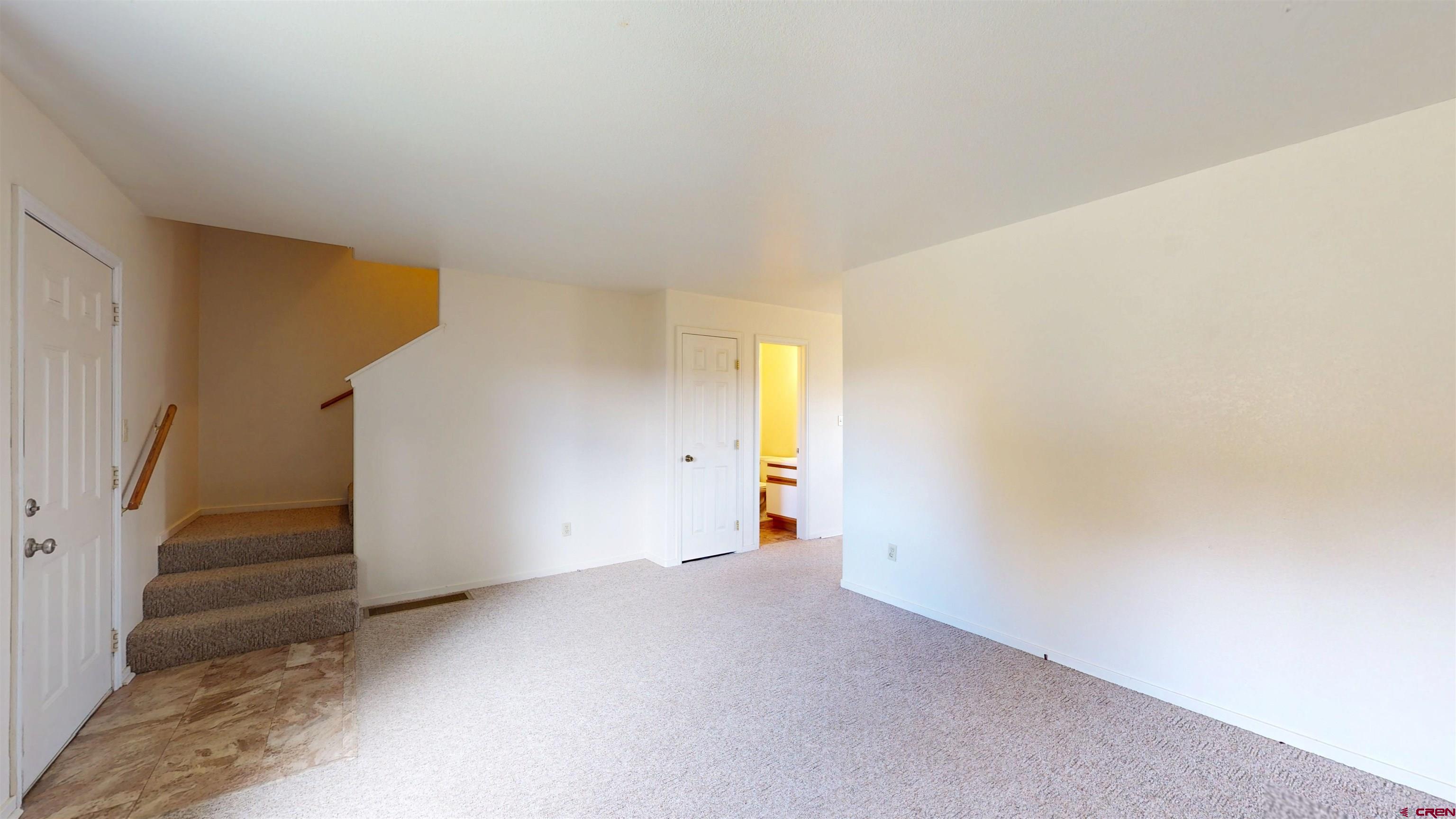 a view of an empty room with stairs