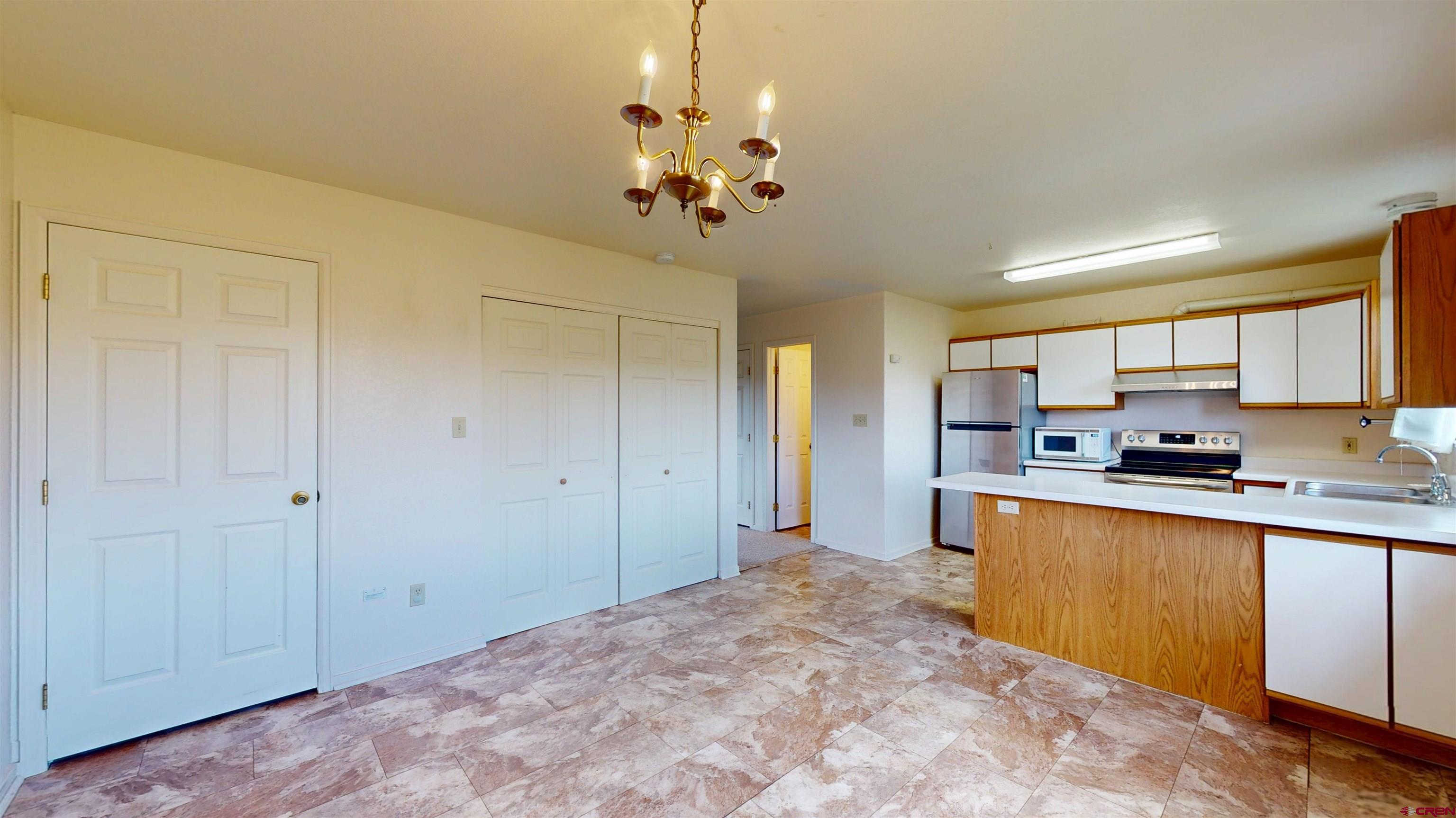 314 South 5th Street Gunnison, CO 81230 - Photo 14 of 26 a open kitchen with stainless steel appliances granite countertop a sink dishwasher a stove and a refrigerator with wooden floor