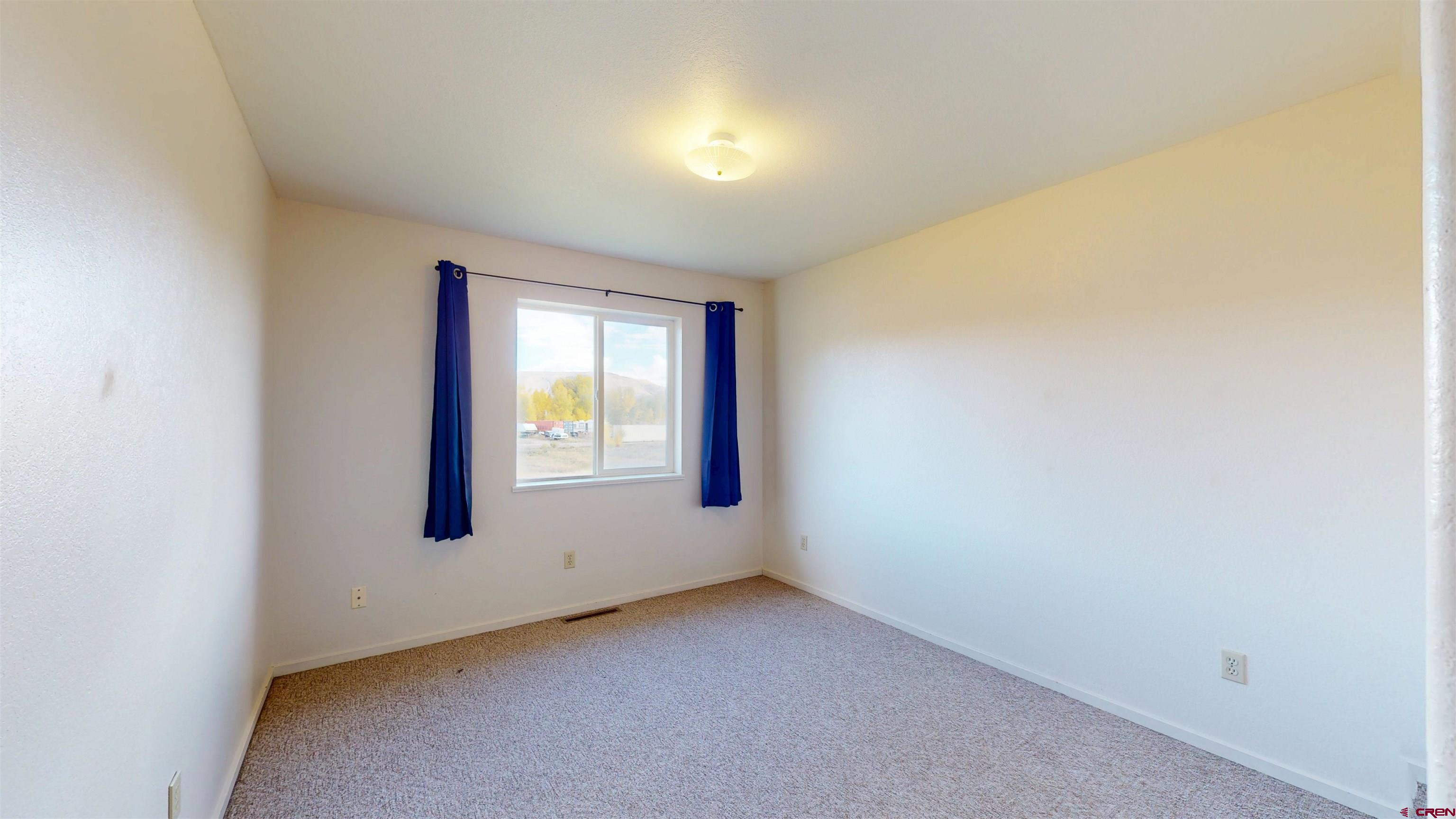 314 South 5th Street Gunnison, CO 81230 - Photo 19 of 26 an empty room with a window