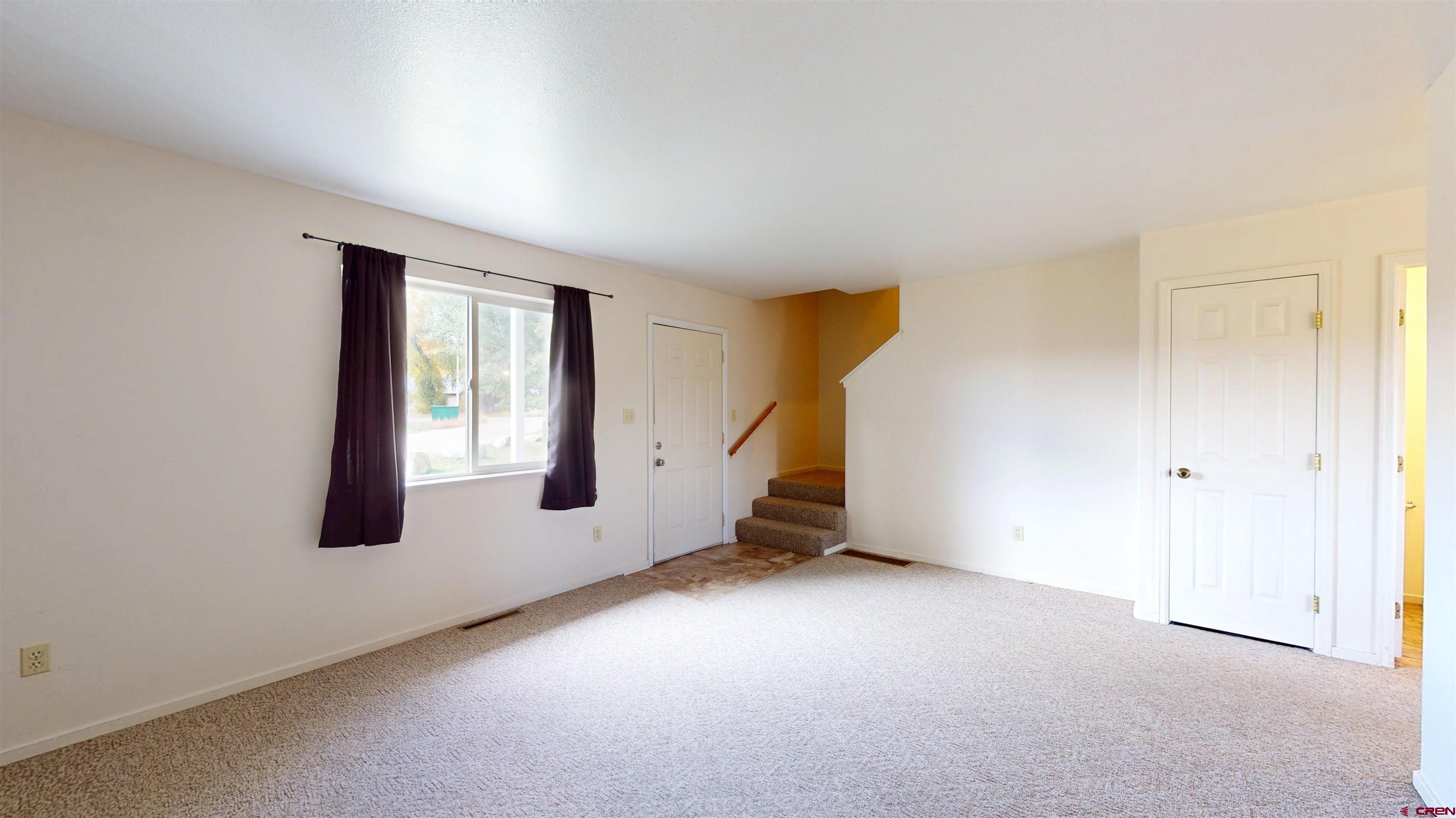 314 South 5th Street Gunnison, CO 81230 - Photo 2 of 26 an empty room with windows