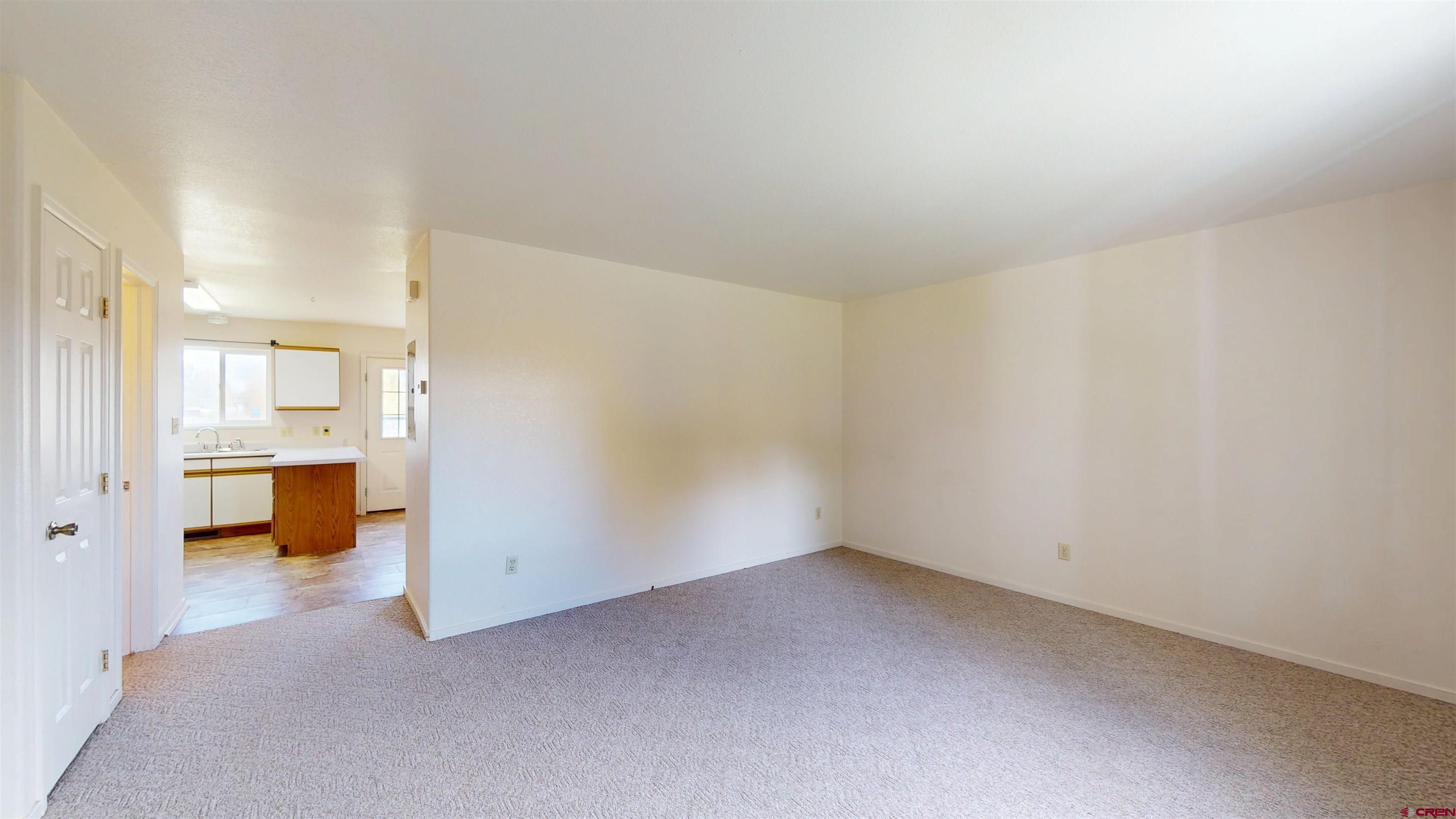 314 South 5th Street Gunnison, CO 81230 - Photo 3 of 26 a view of an empty room and a kitchen