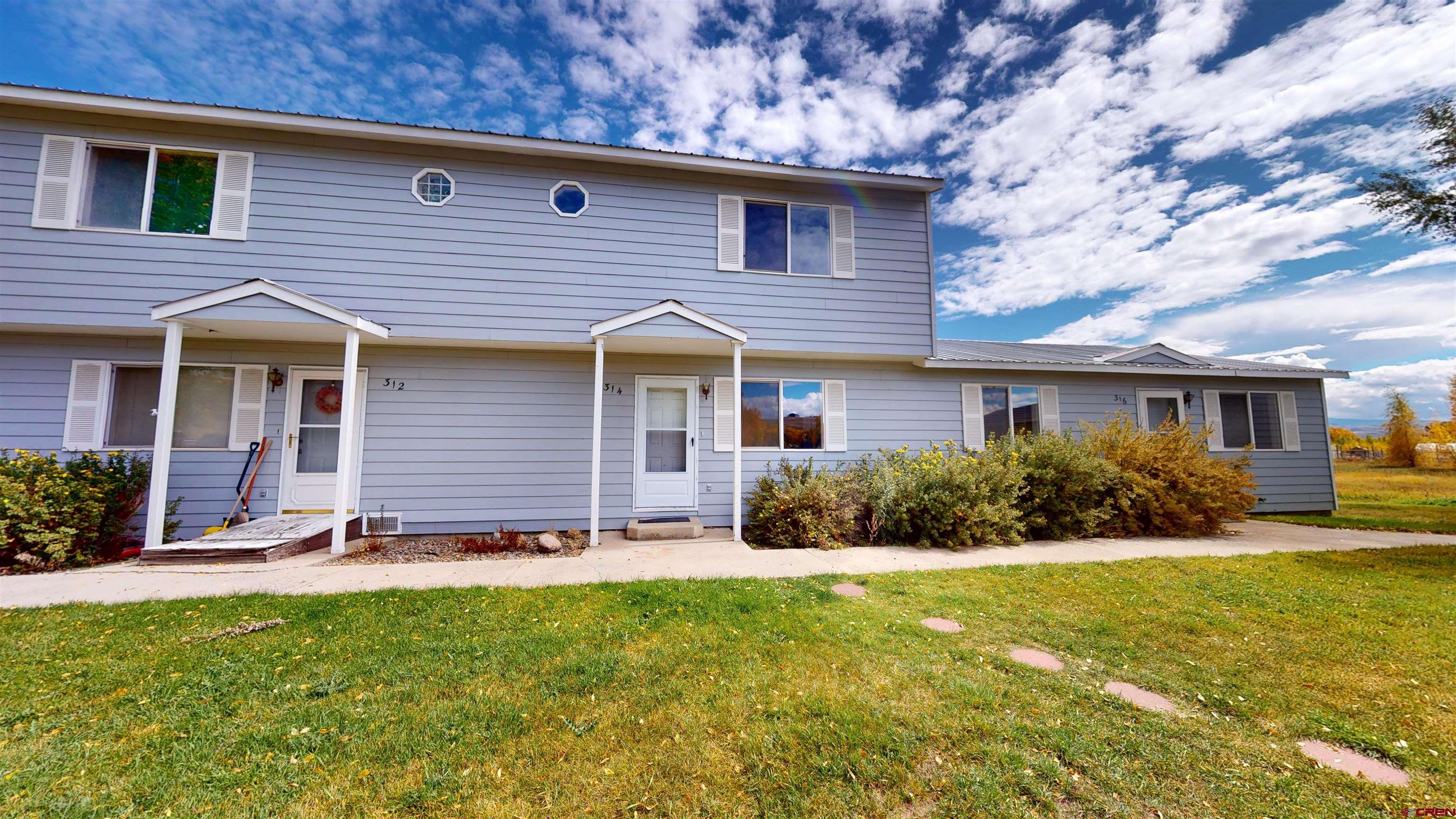 314 South 5th Street Gunnison, CO 81230 - Photo 6 of 26 a front view of a house with garden and trees