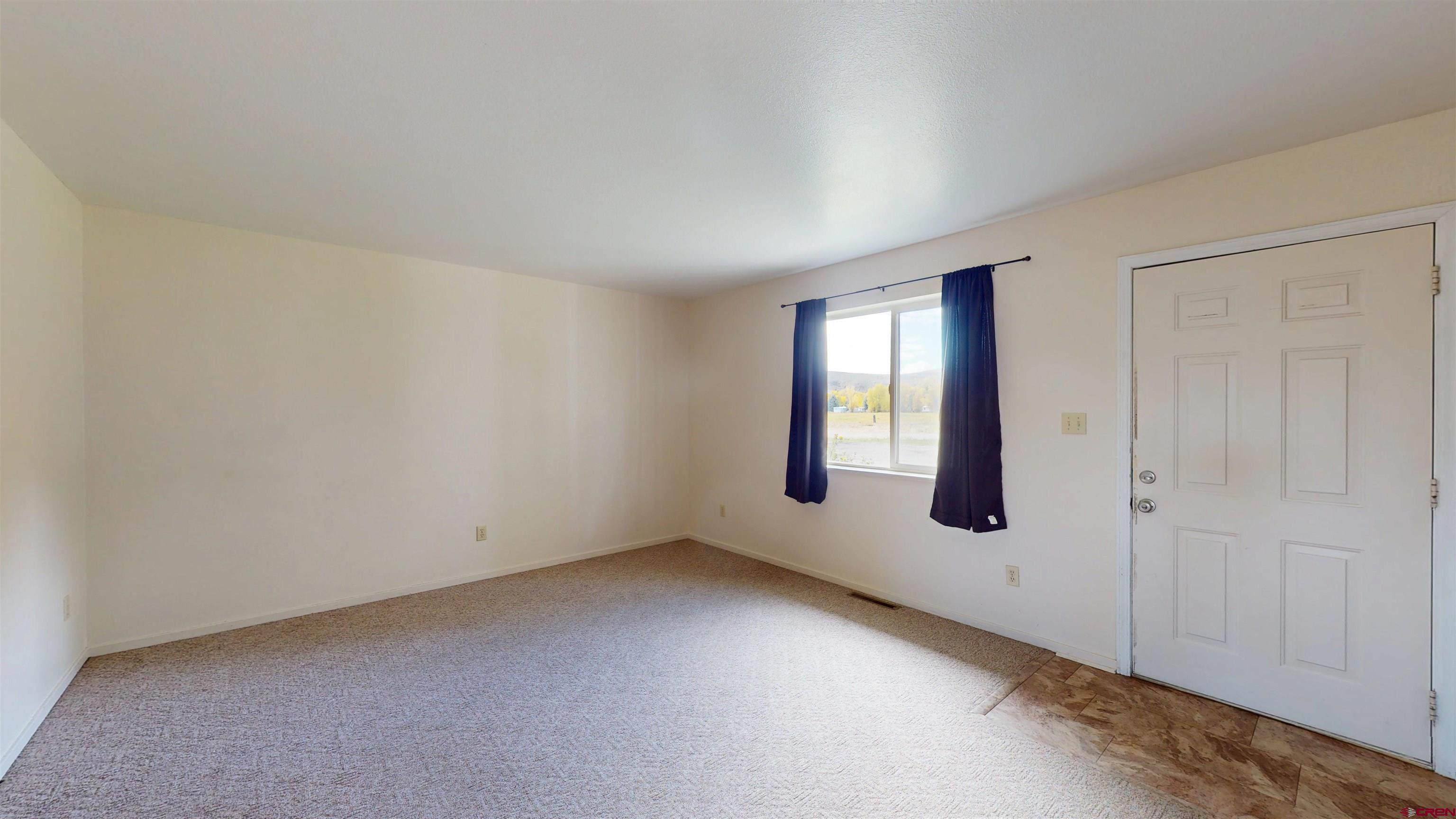 314 South 5th Street Gunnison, CO 81230 - Photo 7 of 26 an empty room with windows