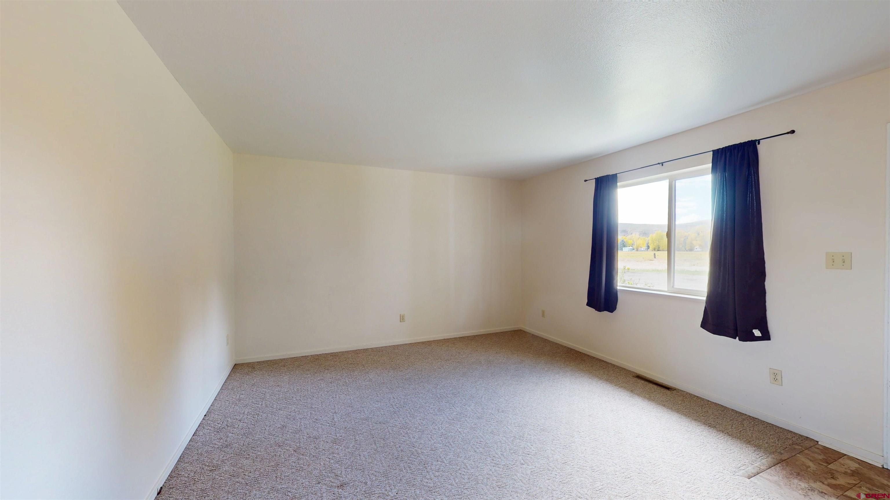 314 South 5th Street Gunnison, CO 81230 - Photo 8 of 26 an empty room with windows