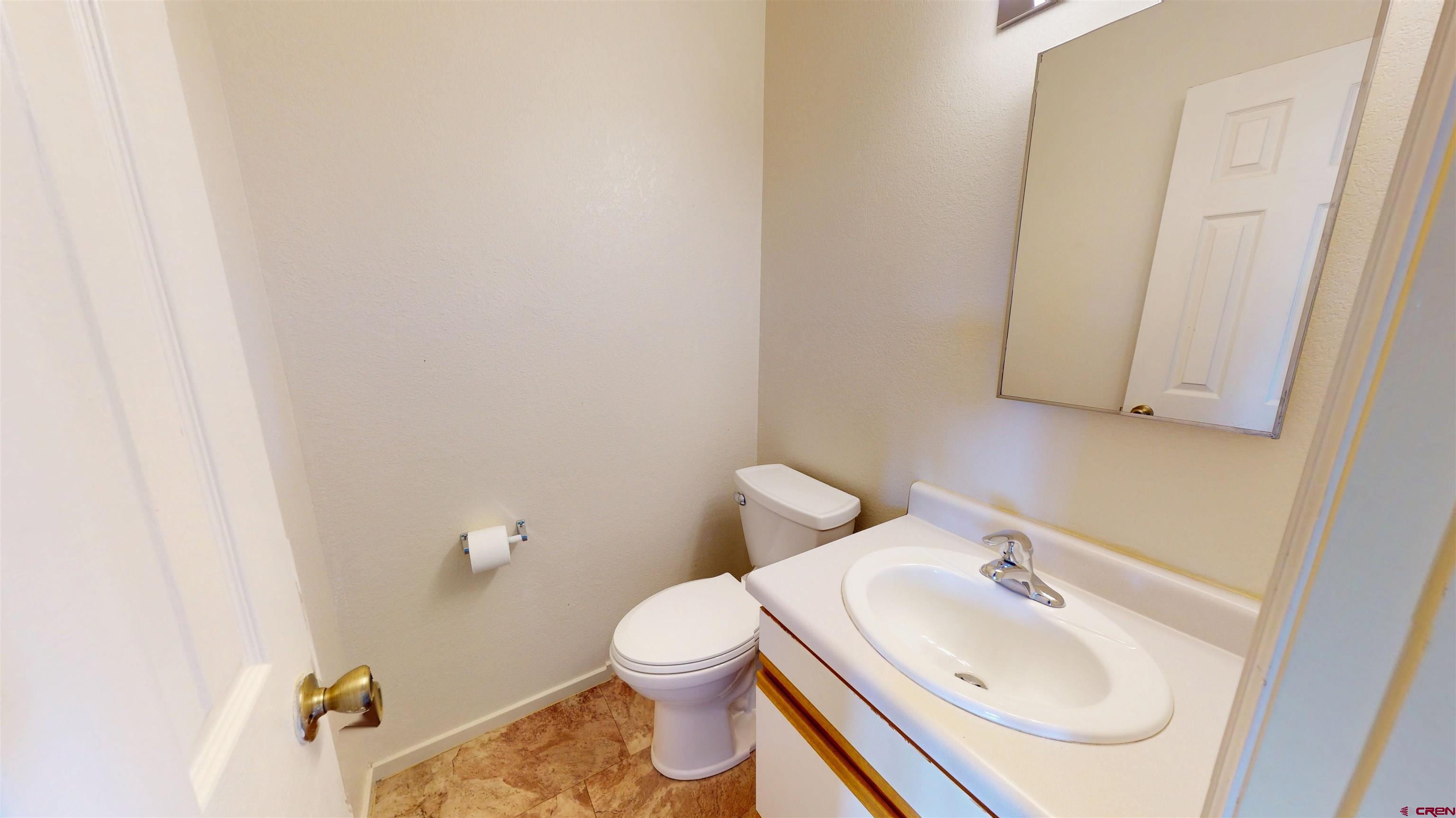 314 South 5th Street Gunnison, CO 81230 - Photo 9 of 26 a bathroom with a sink toilet and mirror