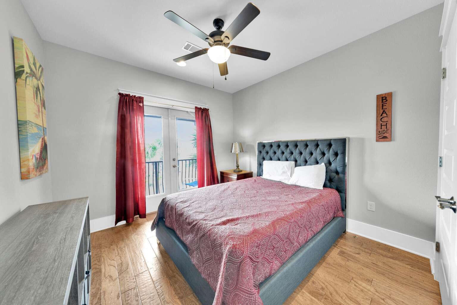 228 Miami Street Miramar Beach, FL 32550 - Photo 11 of 20 a bedroom with a large bed and a chandelier
